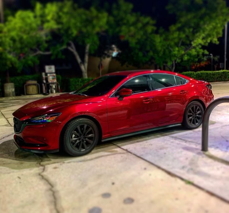 A picture of a Mazda Axela that is red in colour