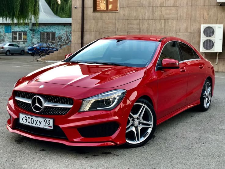 A picture of a Mercedes Benz that is red in colour